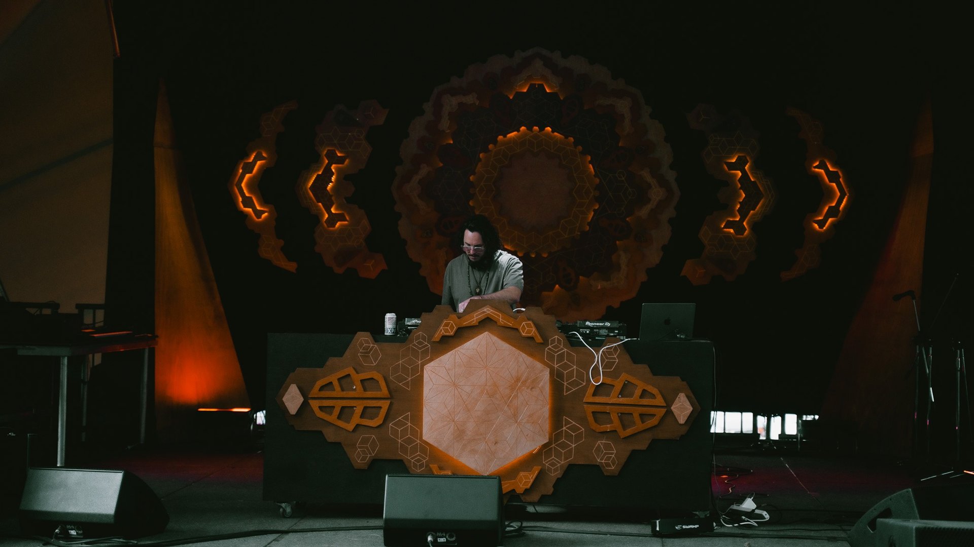 KUNI performing live on stage under warm lighting